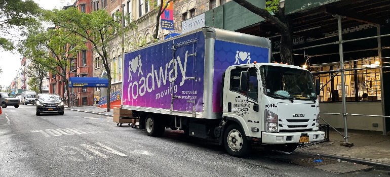 a moving truck parked in front of the building 