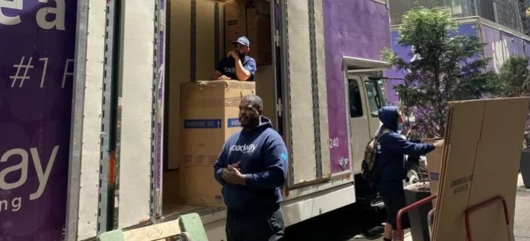 Roadway movers loading a moving truck