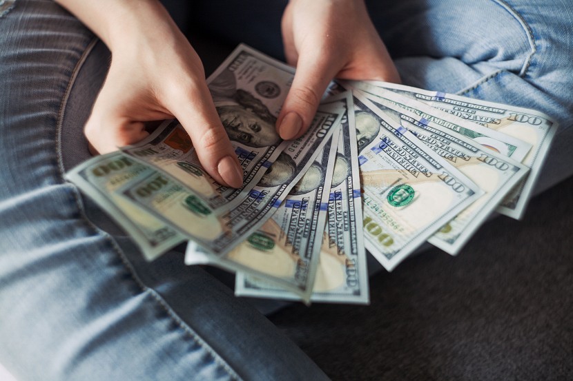 Girl holding american dollar bills