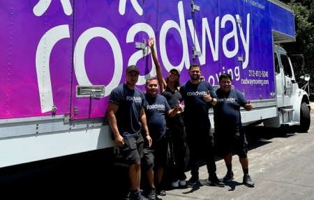 Roadway Moving's crew with a happy customer